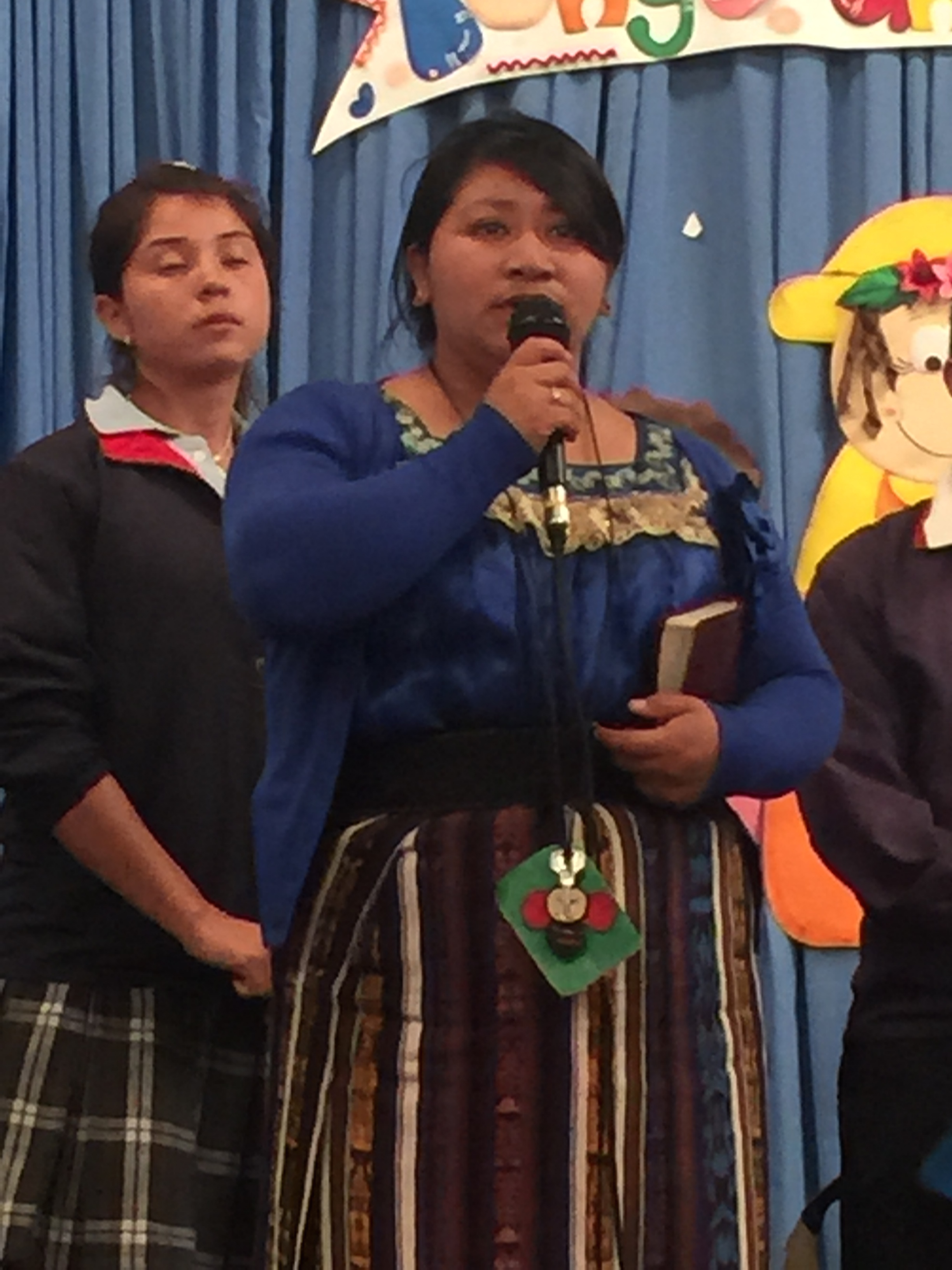 Teacher leading prayer with Isa